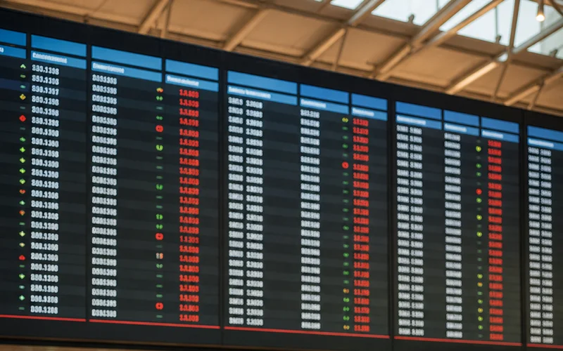 airline prices fluctuating on departure board at international airport.